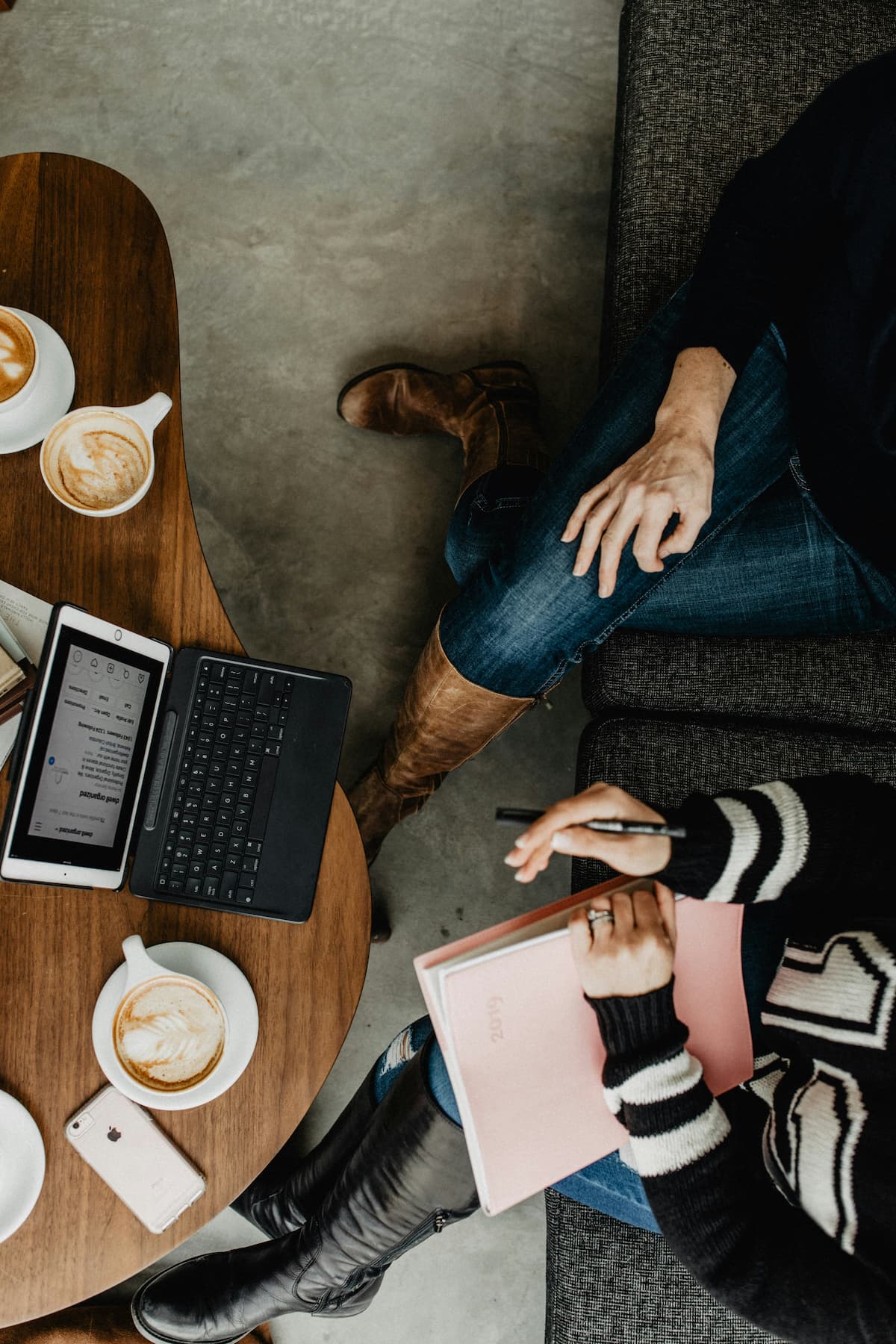 Working over notebooks and coffee at a table